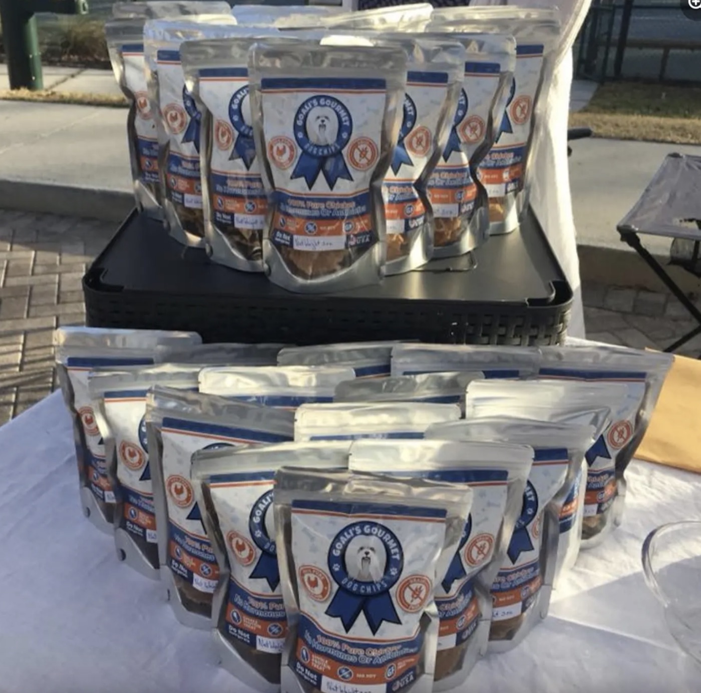 Screenshot Bags of Goali's Gourmet dog chips on a market stall table